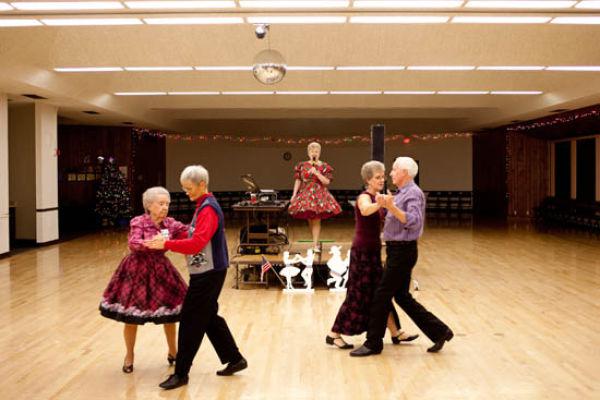 anne-brown-rigg-calls-during-a-round-dance-as-couples-pass-by-during-a-night-of-round-and-square-dancing-in-a-social-hall-in-sun-city-arizona-december-8-2009-because-there-are-less-men-available-s anne-brown-rigg-calls-during-a-round-dance-as-couples-pass-by-during-a-night-of-round-and-square-dancing-in-a-social-hall-in-sun-city-arizona-december-8-2009-because-there-are-less-men-available-s